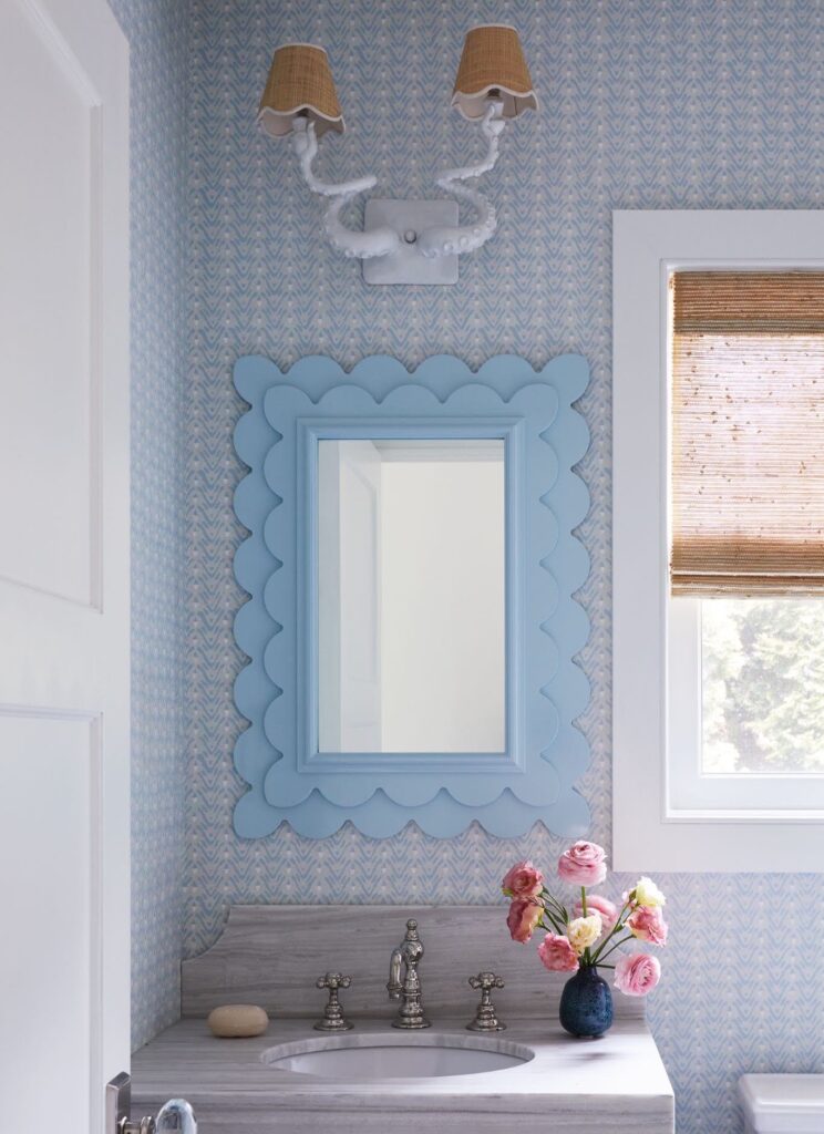 Manasquan powder room with a custom octopus sconce by Adam Wallacavage, scalloped Oomph mirror and Galbraith and Paul wallpaper.