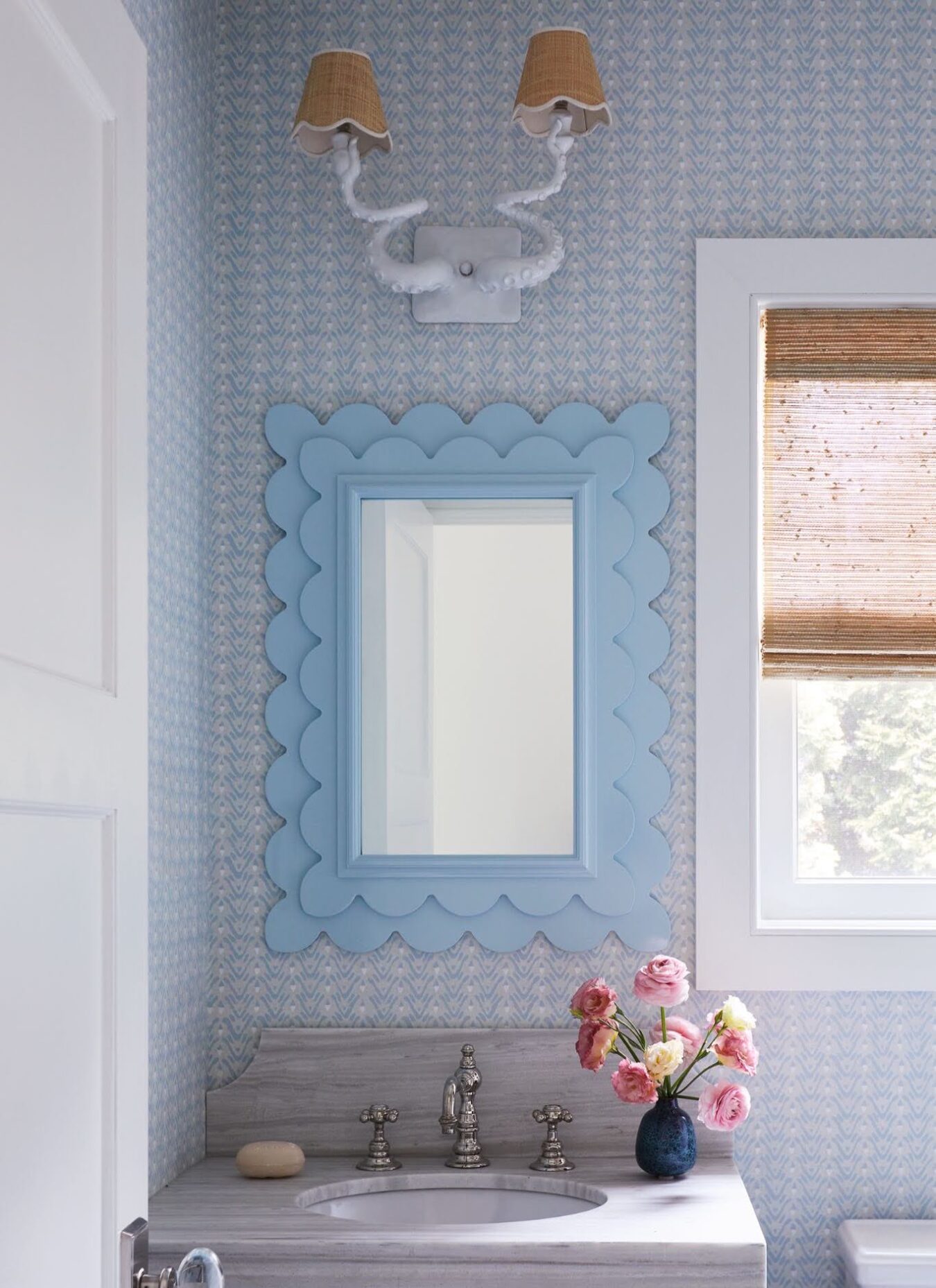 Manasquan powder room with a custom octopus sconce by Adam Wallacavage, scalloped Oomph mirror and Galbraith and Paul wallpaper.
